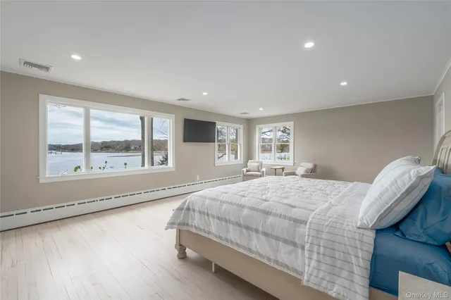 a bedroom with a bed and a large window