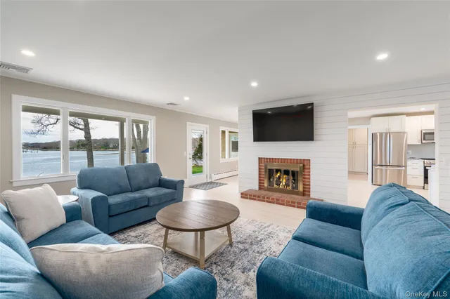 a living room with furniture a fireplace and a flat screen tv