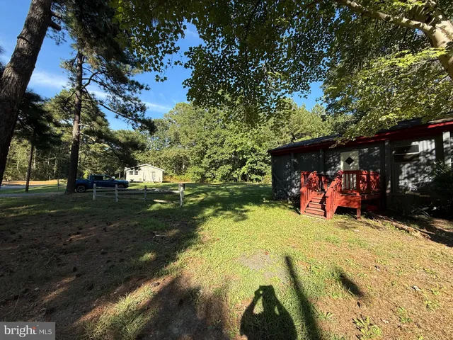 a front view of house with yard and trees