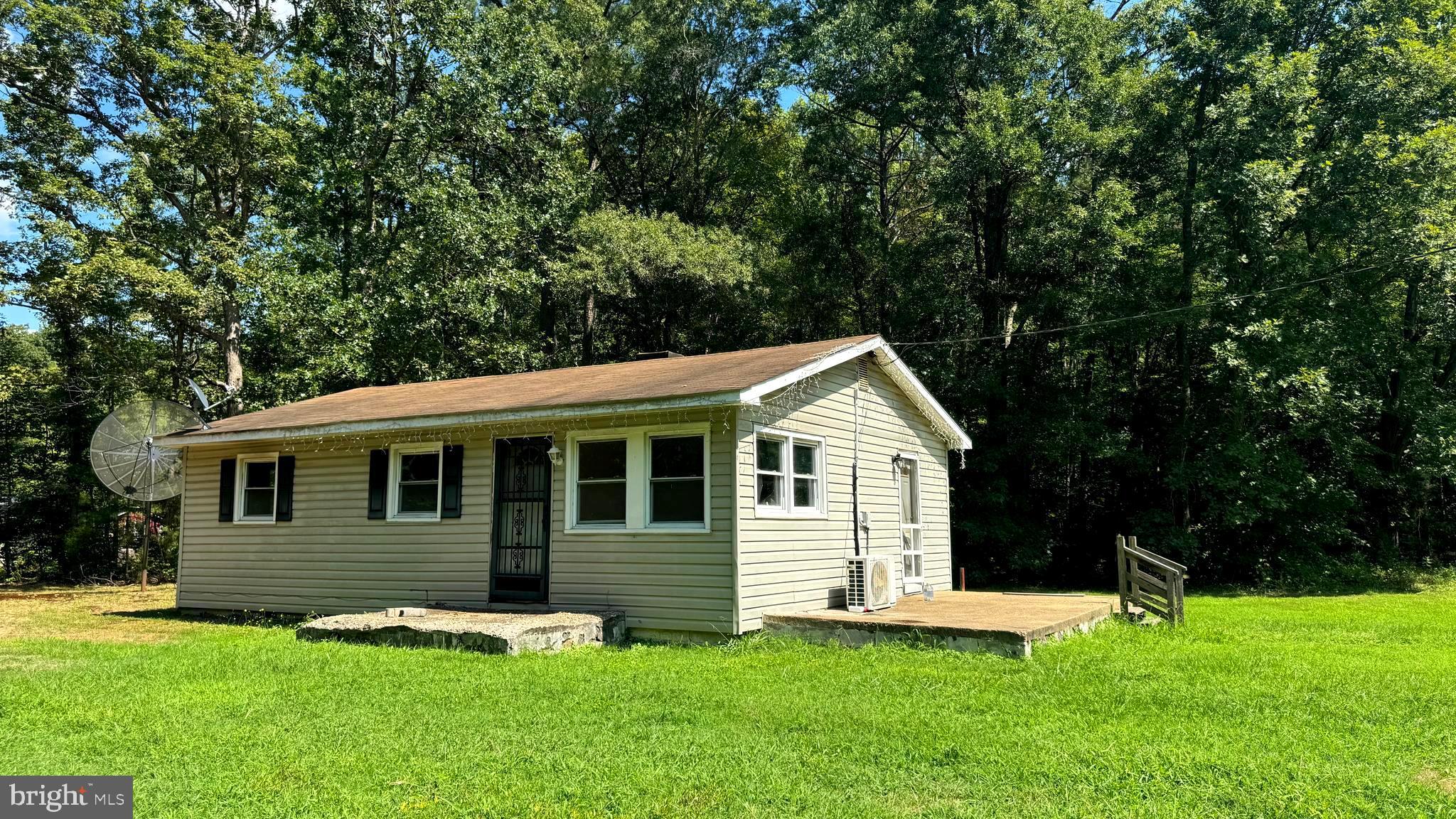 14405 Millbank Road King George, VA 22485 - Photo 4 of 20 a backyard of a house with yard table and chairs