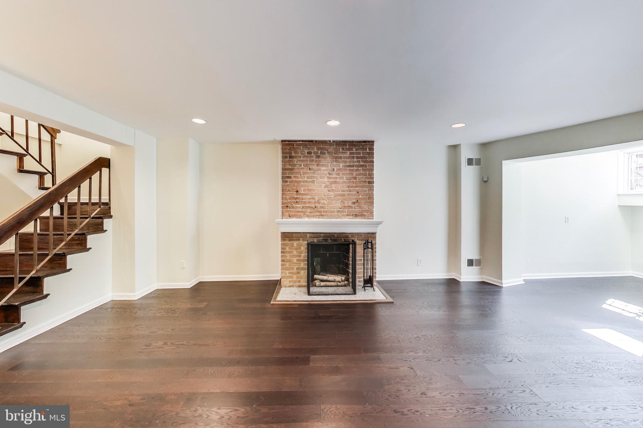 1625 S Street Northwest, Unit 1 Washington, DC 20009 - Photo 4 of 13 a view of an empty room with wooden floor fire place and windows