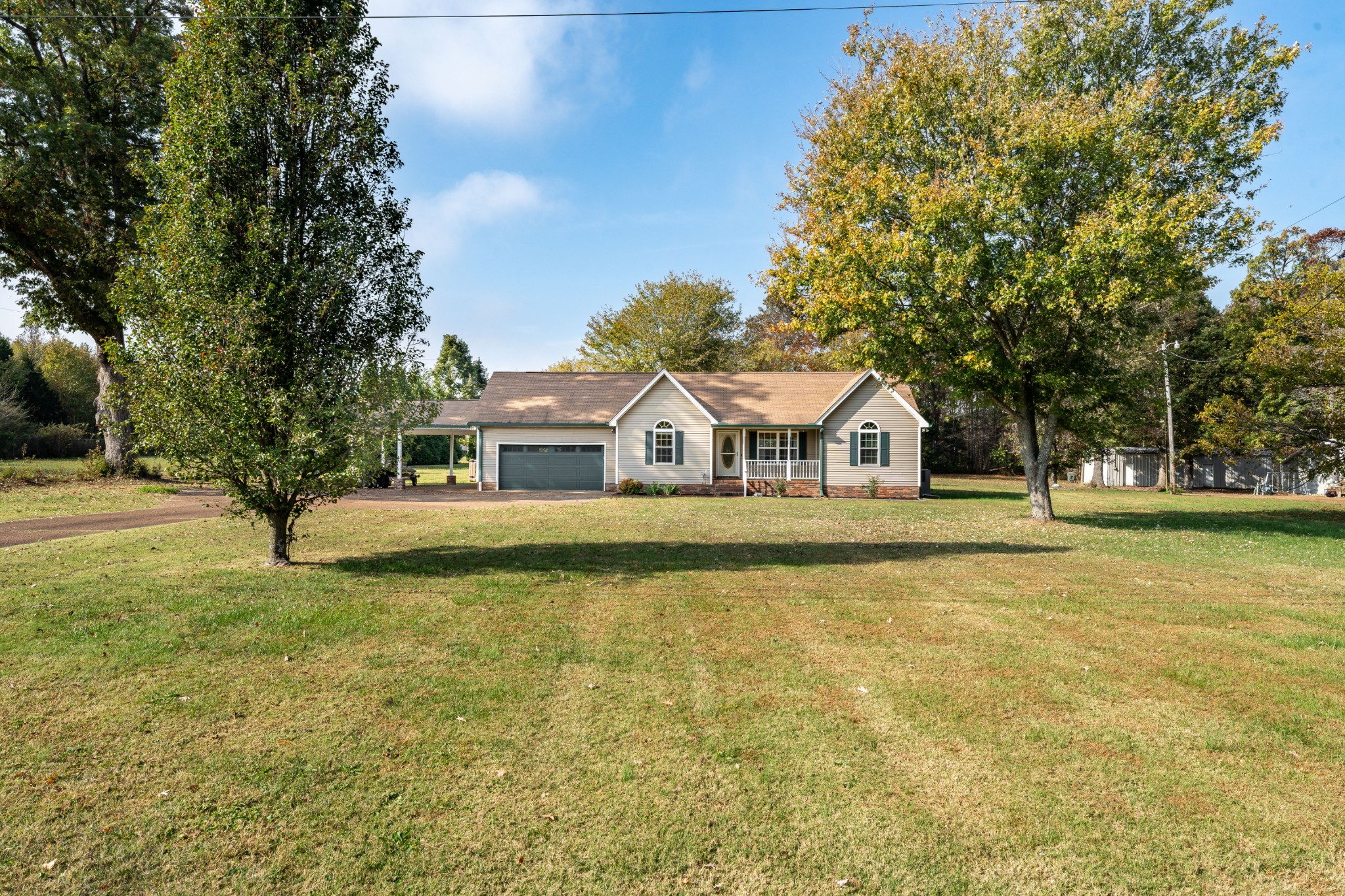 3053 Academy Road Portland, TN 37148 - Photo 12 of 45 a front view of a house with a yard and trees