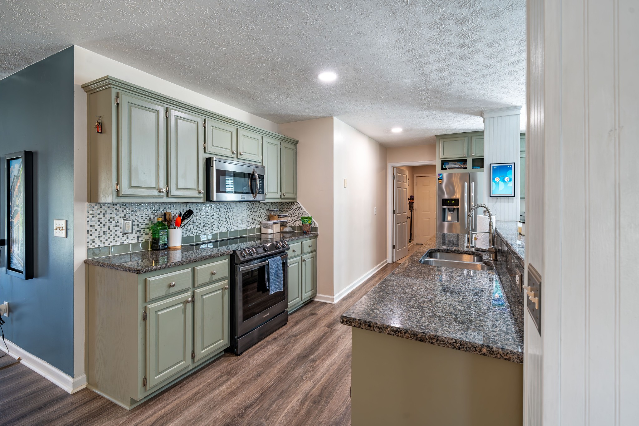 3053 Academy Road Portland, TN 37148 - Photo 25 of 45 a kitchen with granite countertop stainless steel appliances and wooden cabinets