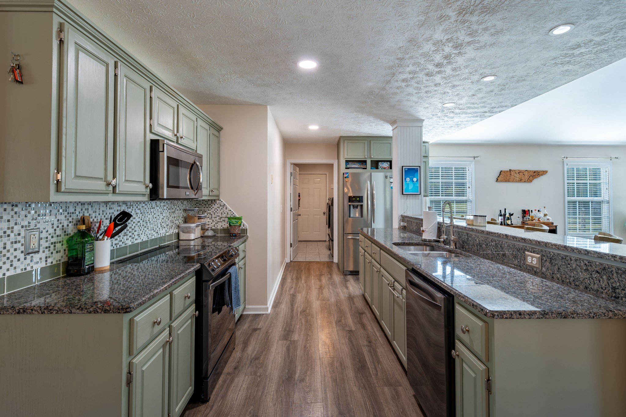 3053 Academy Road Portland, TN 37148 - Photo 26 of 45 a kitchen with stainless steel appliances granite countertop sink stove top oven and refrigerator