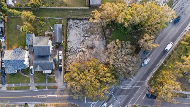 an aerial view of a house with a yard