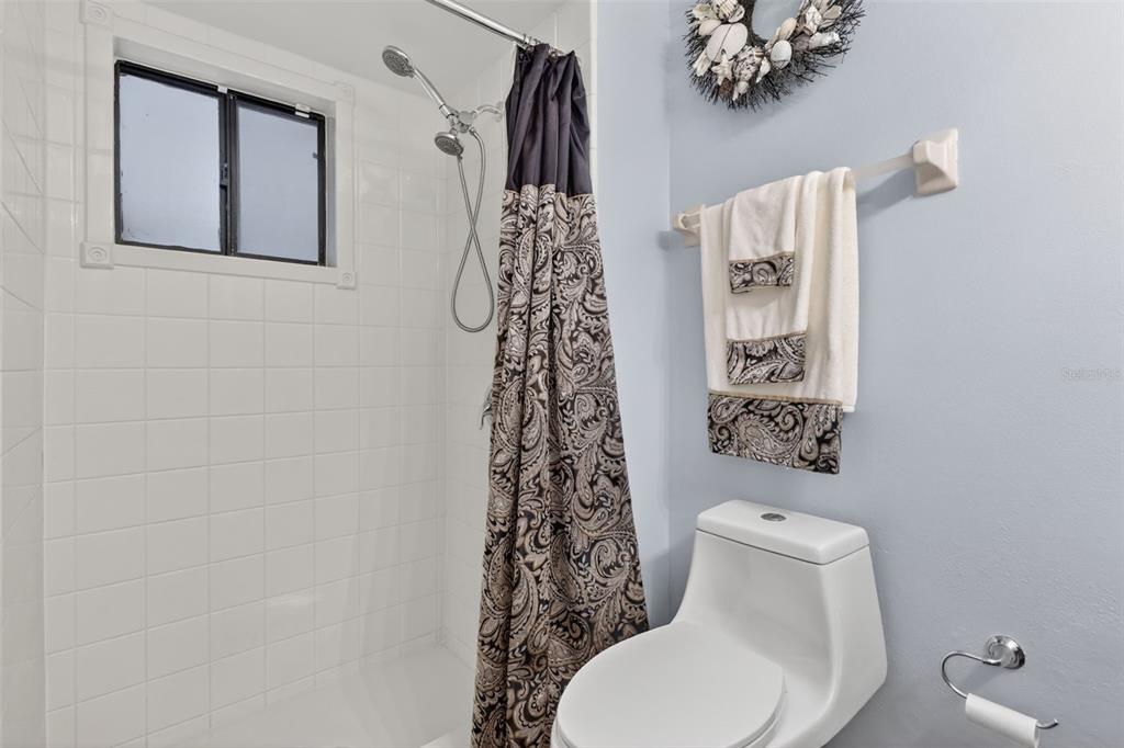 575 Tiberon Cove Road Longwood, FL 32750 - Photo 33 of 56 a bathroom with a toilet and a shower curtain