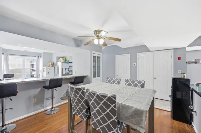a view of a dining room with furniture and wooden floor