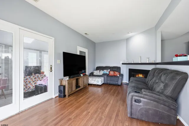 a living room with furniture a flat screen tv and a fireplace