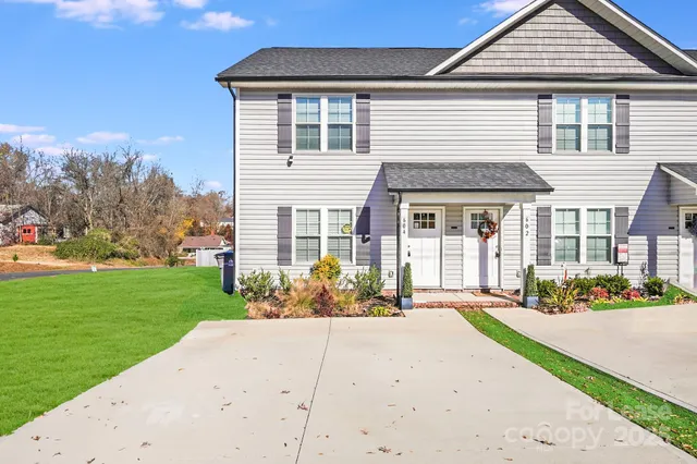 a front view of a house with a garden and pathway