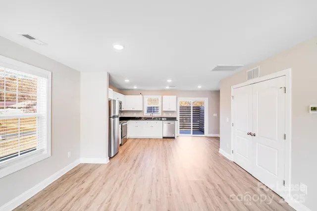 a kitchen with a sink a refrigerator and window