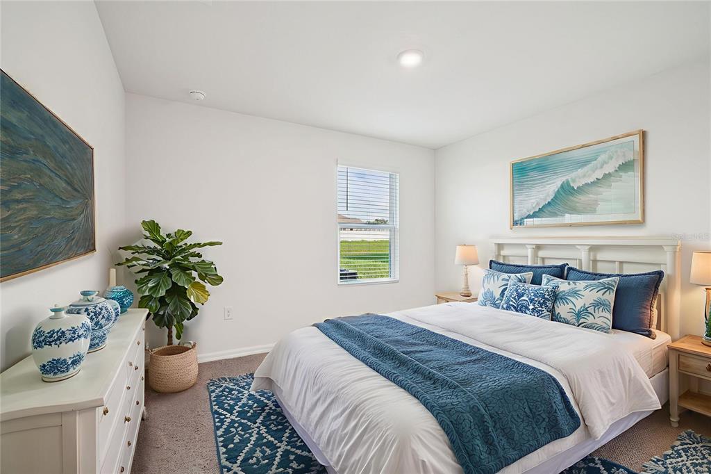 7067 Southeast 113th Place Belleview, FL 34420 - Photo 4 of 11 a bedroom with bed and a potted plant