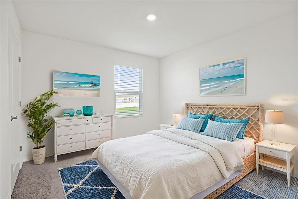 7067 Southeast 113th Place Belleview, FL 34420 - Photo 6 of 11 a bedroom with a large bed and a potted plant