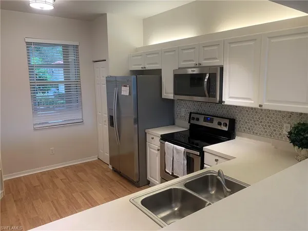 a kitchen that has a sink and a stove in it