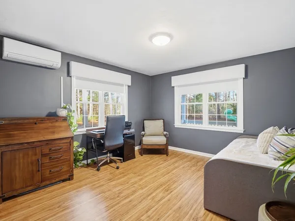 a bedroom with furniture and a wooden floor