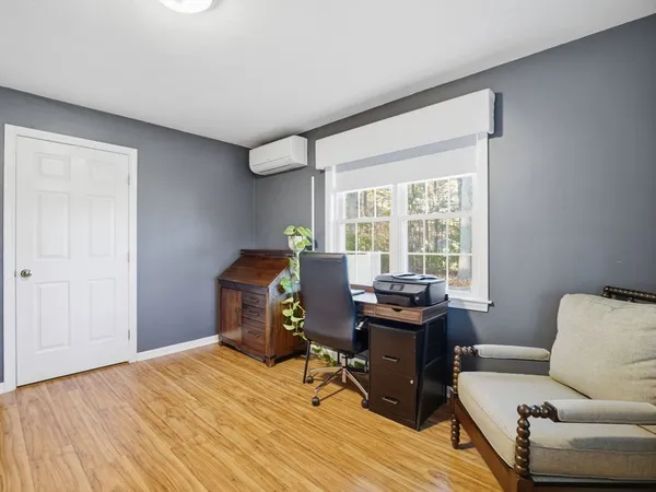 a view of a workspace with furniture and a window
