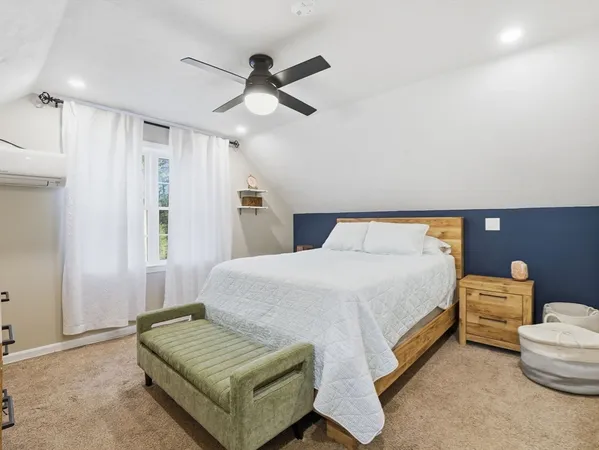 a bedroom with bed and window