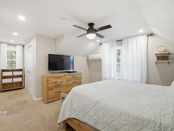 a bedroom with a bed and a flat screen tv