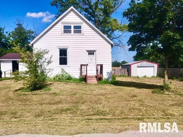 a view of a house with a yard and tree s