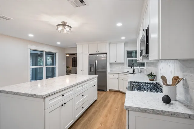 a bathroom with a granite countertop toilet a sink and a bathtub