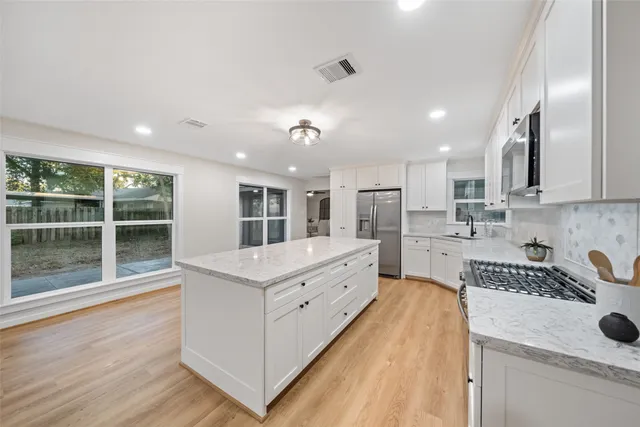 a bathroom with a tub a sink and a mirror