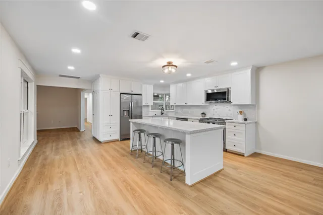 a bathroom with a double vanity sink a mirror a shower and vanity