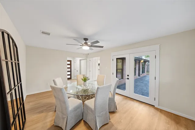 a kitchen with stainless steel appliances a sink dishwasher stove and microwave with wooden floor