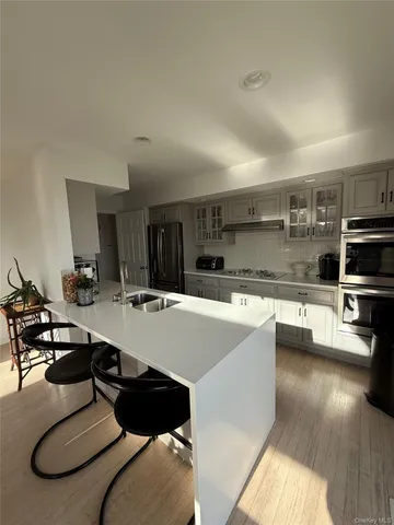 a large white kitchen with a large window