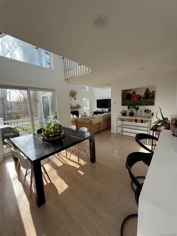 a living room with furniture a flat screen tv and a table