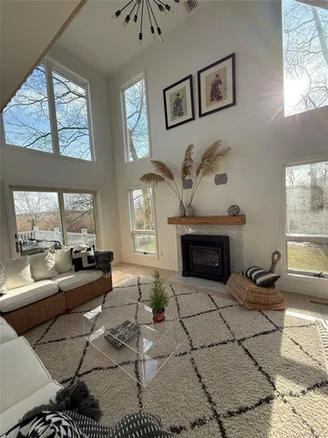 a living room with furniture a large window and a fireplace