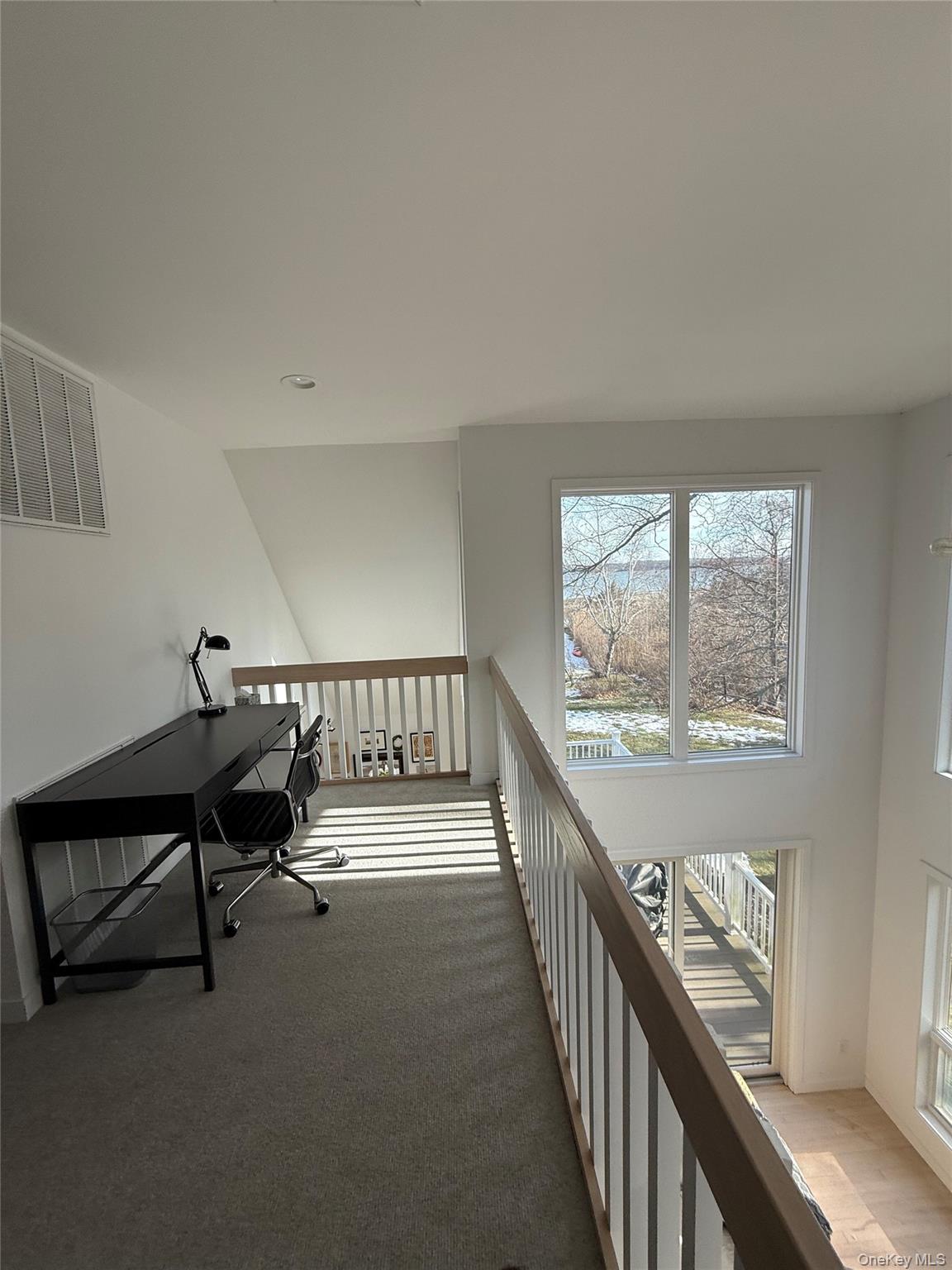 845 Budds Pond Road Southold, NY 11971 - Photo 9 of 9 a view of a hallway with wooden floor and stairs