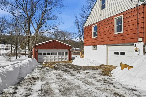 a view of a house with snow on the road