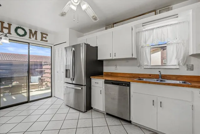 a kitchen with a sink a refrigerator and cabinets
