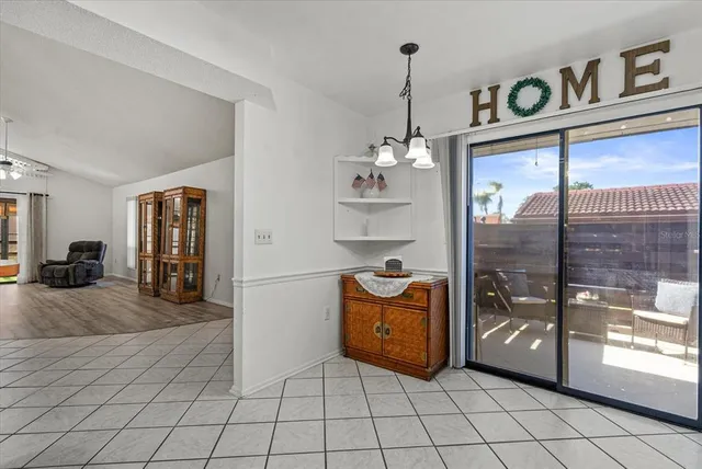 a very nice looking empty room with window and chandelier