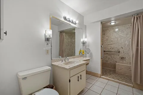 a bathroom with a shower sink vanity and mirror