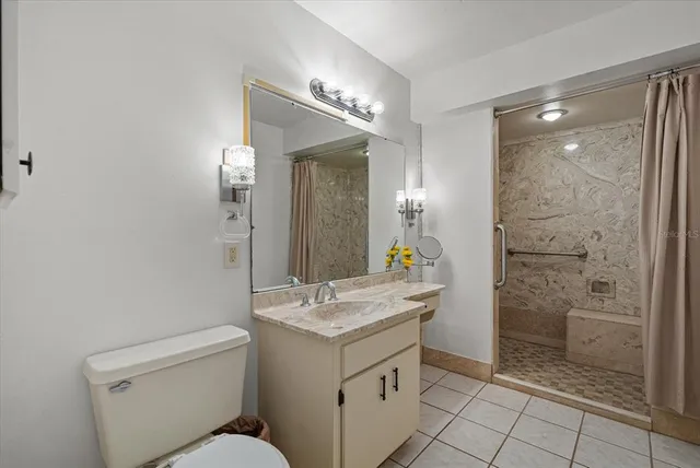 a bathroom with a shower sink vanity and mirror