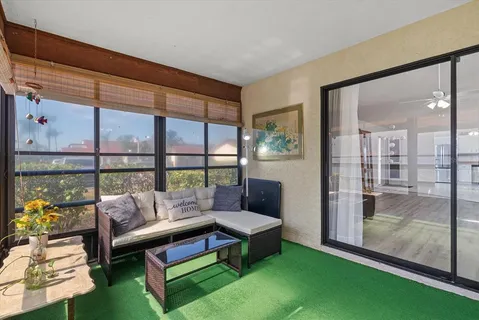 a living room with furniture and a floor to ceiling window