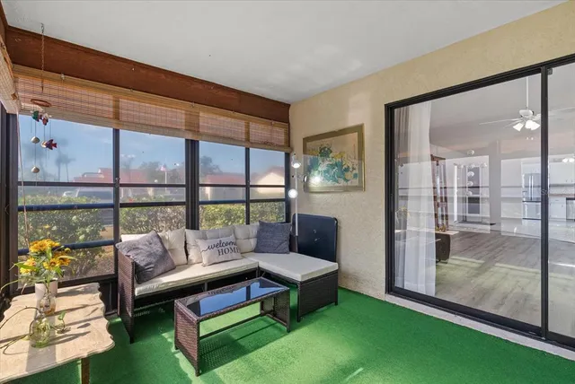 a living room with furniture and a floor to ceiling window
