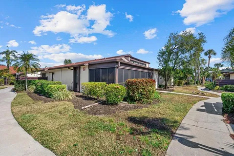 a view of a house with backyard and tree s