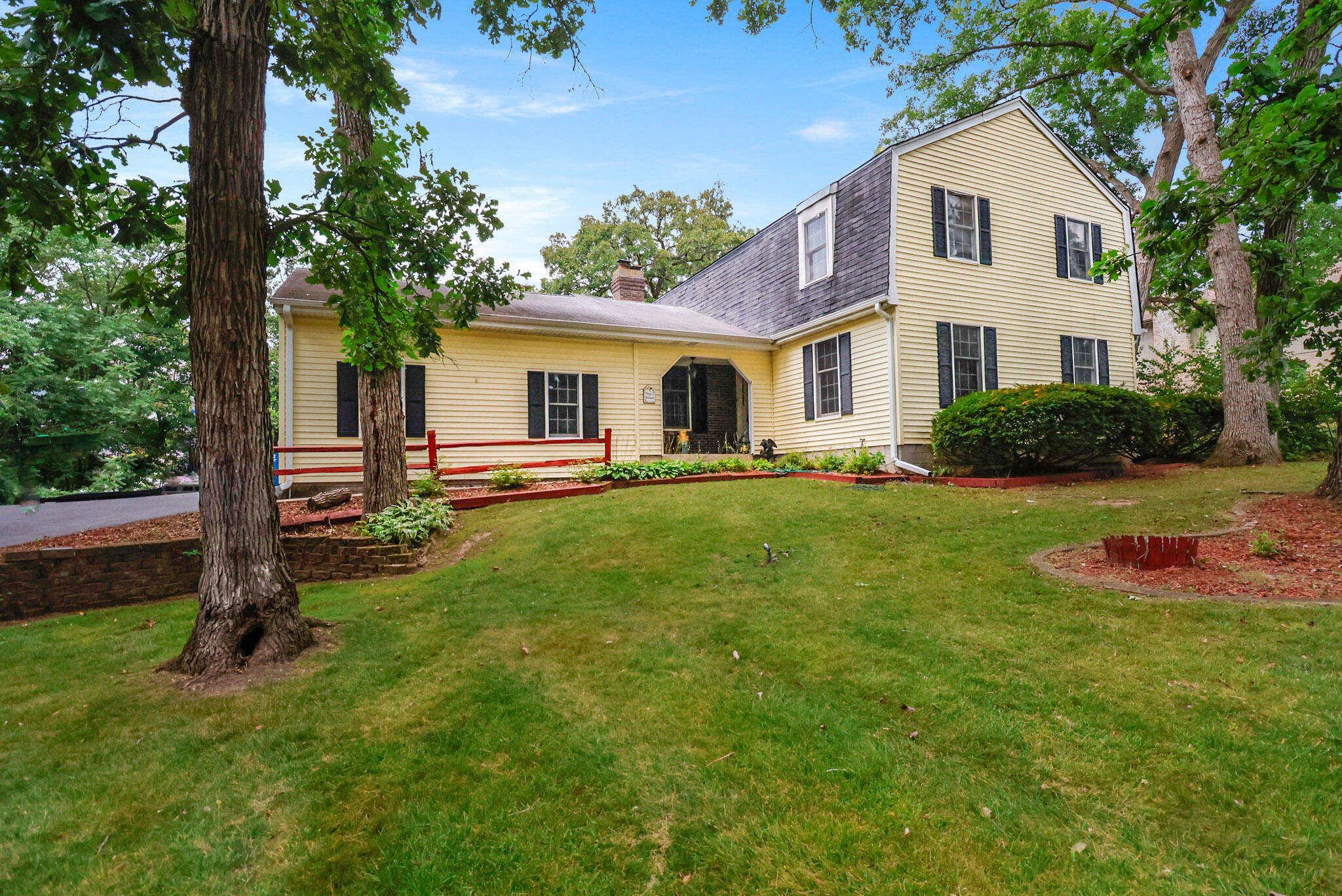 8670 Howard Street St. John, IN 46373 - Photo 1 of 34 a front view of a house with a yard and trees