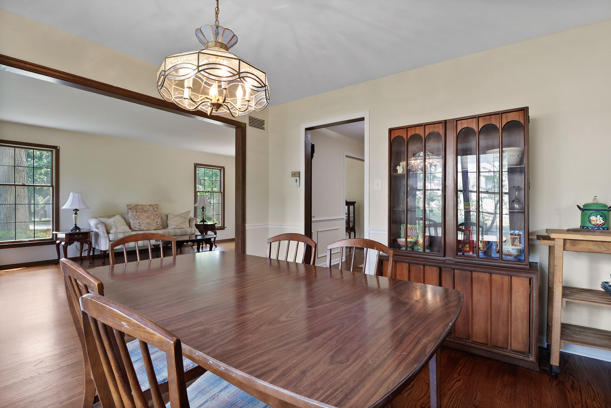 8670 Howard Street St. John, IN 46373 - Photo 11 of 34 a view of dining room and livingroom with furniture wooden floor a chandelier
