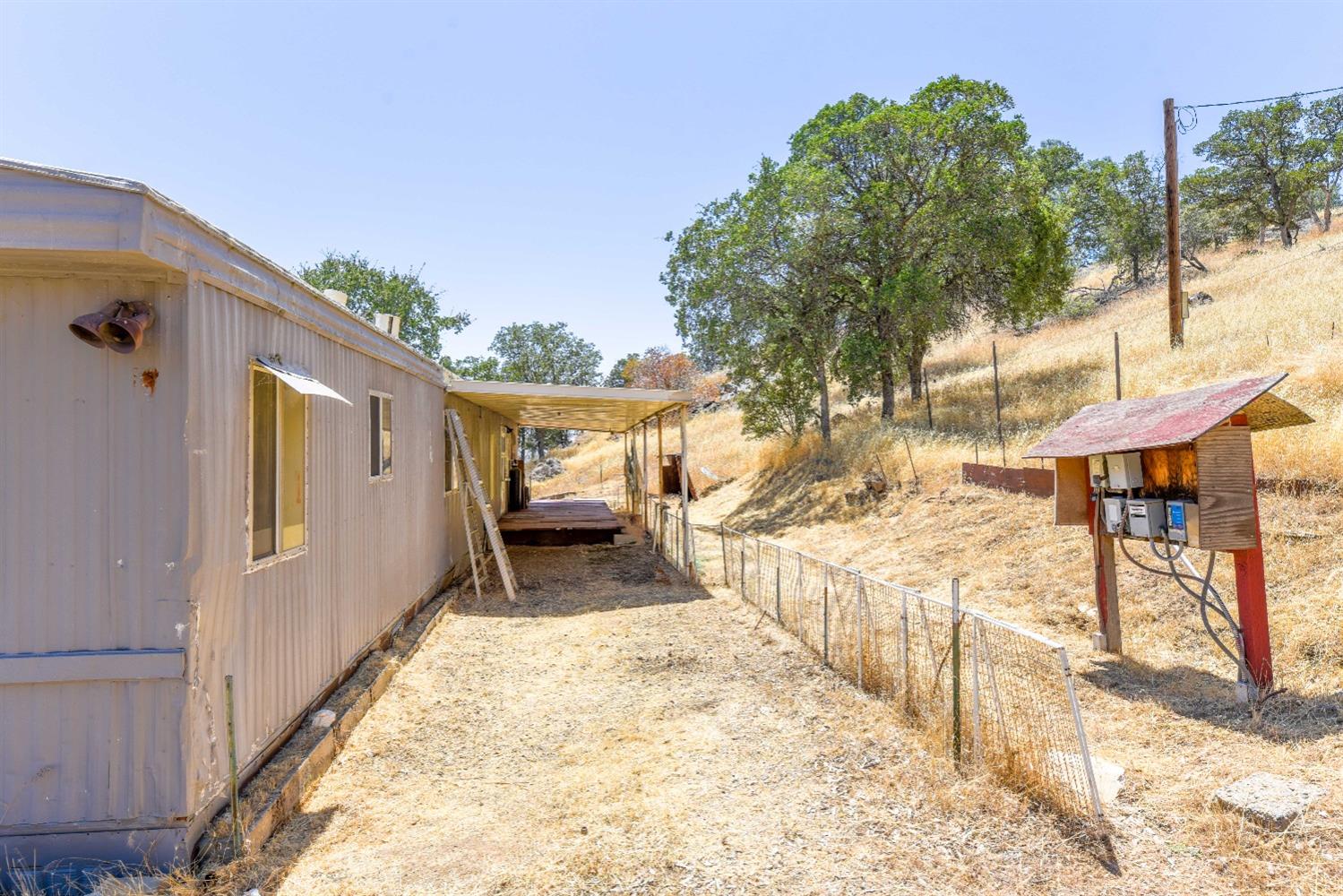 3101 Trower Road Catheys Valley, CA 95306 - Photo 8 of 29 a view of a porch with wooden floor and fence