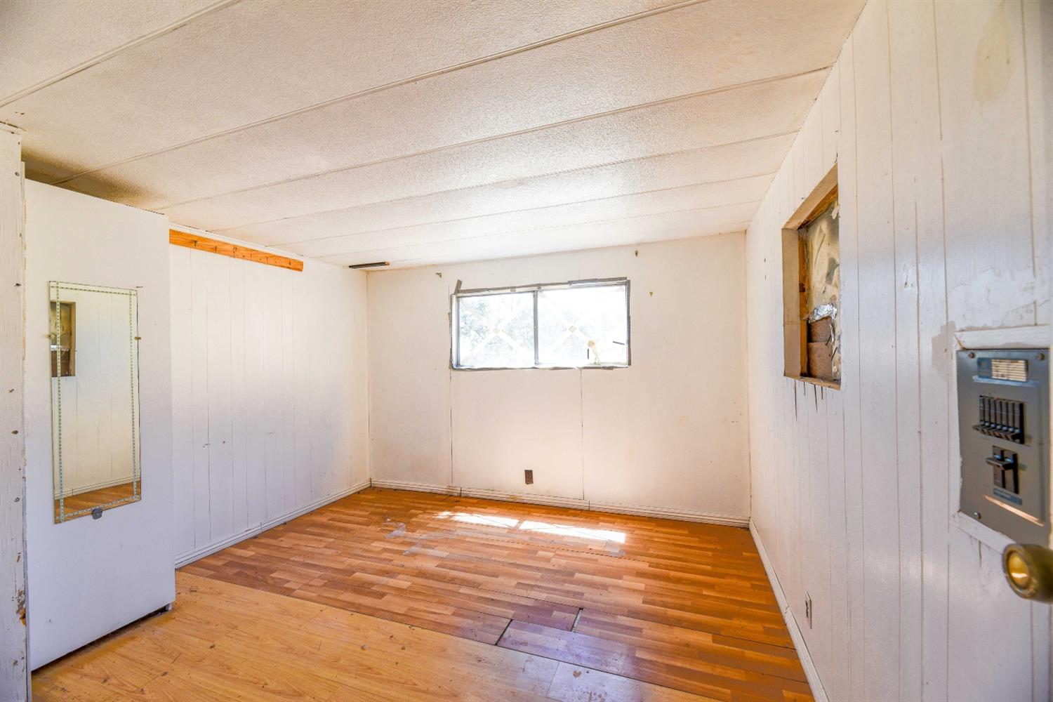 3101 Trower Road Catheys Valley, CA 95306 - Photo 9 of 29 a view of a room with wooden floor and cabinet