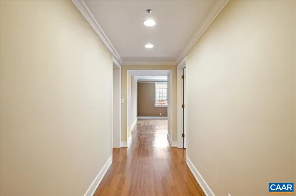 a view of a hallway with wooden floor
