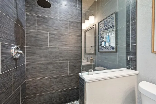 a bathroom with a sink toilet and shower