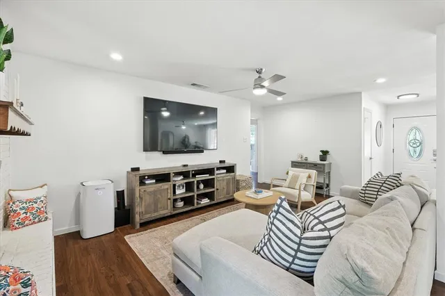 a living room with furniture and a flat screen tv