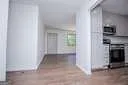 a view of a refrigerator in kitchen and empty room
