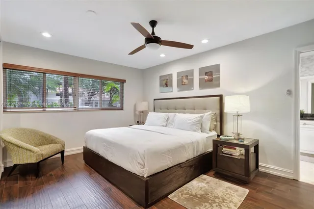 a bedroom with a large bed and a window