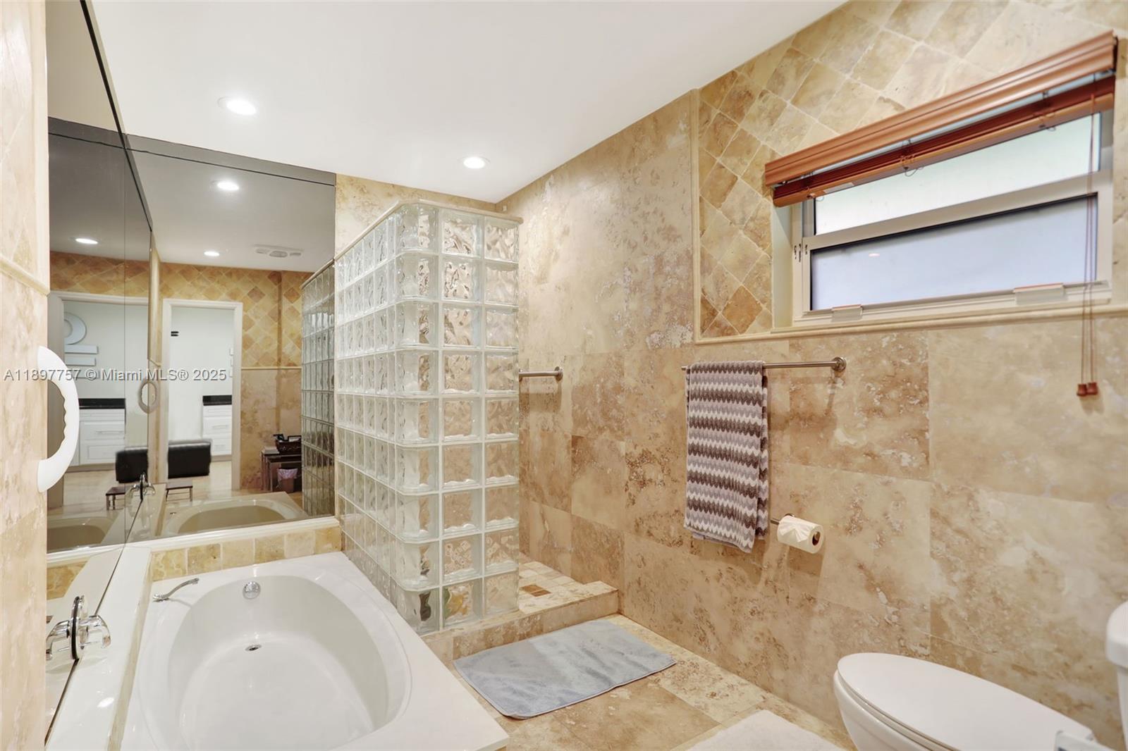 1128 West Cypress Drive, Unit V15 Pompano Beach, FL 33069 - Photo 15 of 41 a bathroom with a sink toilet and shower