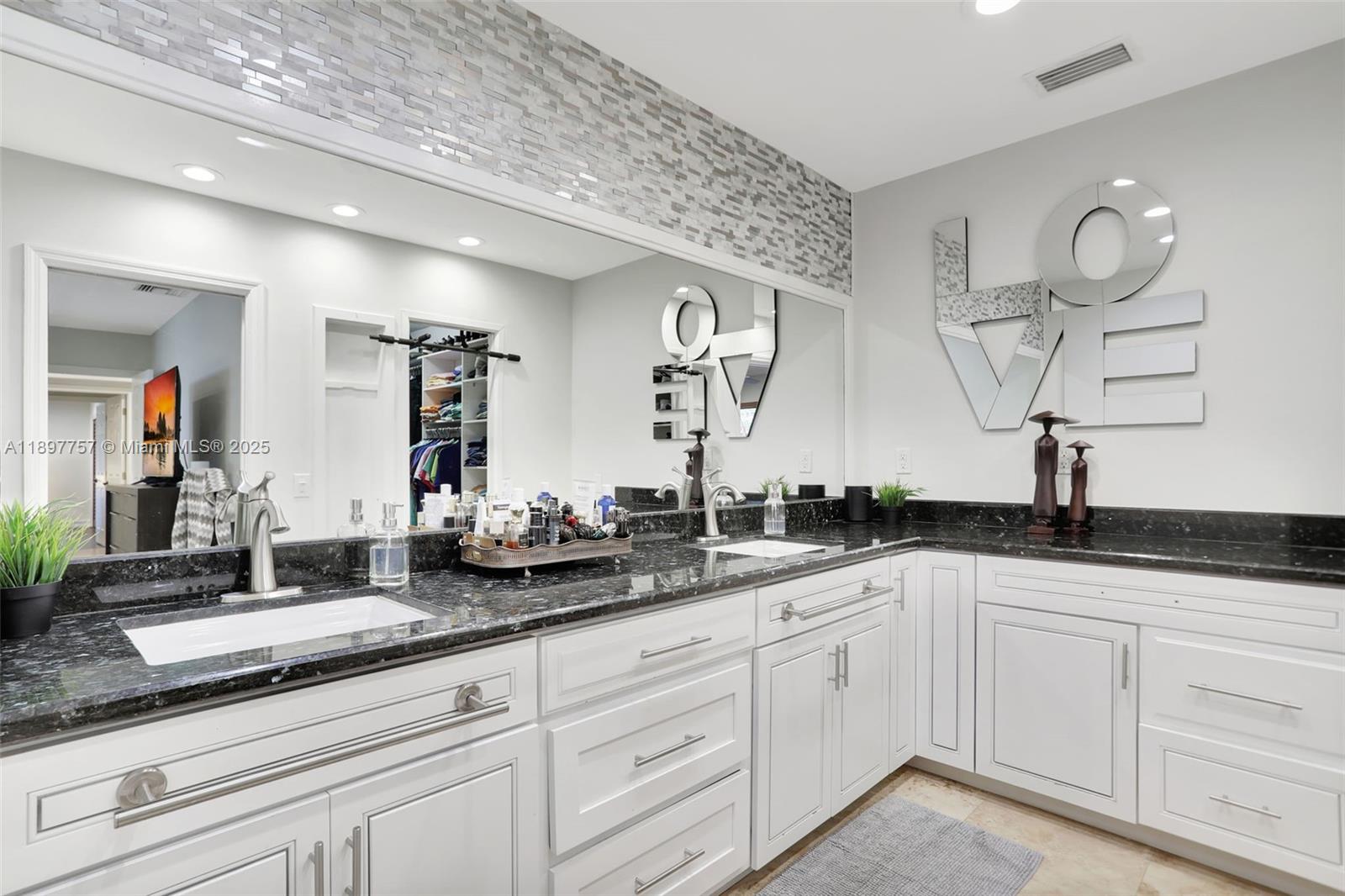 1128 West Cypress Drive, Unit V15 Pompano Beach, FL 33069 - Photo 16 of 41 a bathroom with double vanity sinks a vanity and a mirror
