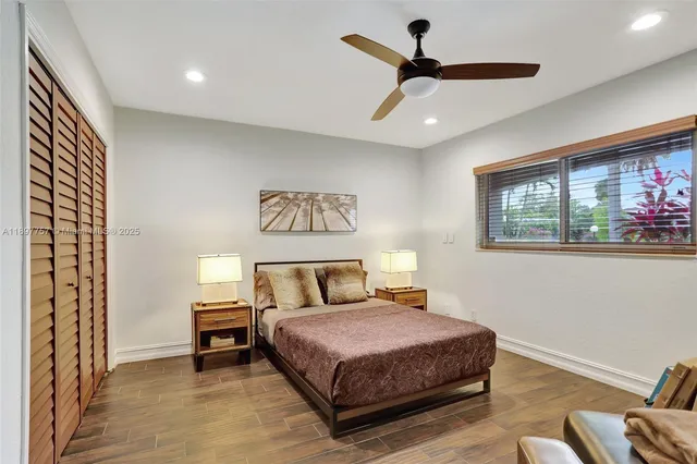 a bedroom with a bed and a painting on the wall